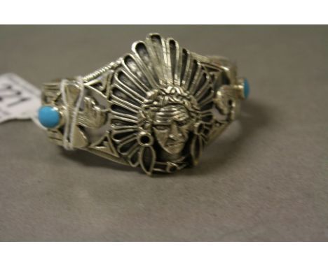 Silver and turquoise bangle in the form of a Native American