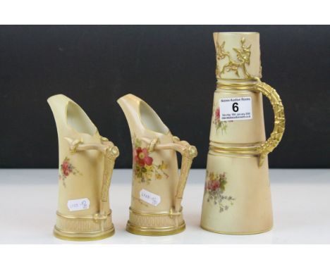 Three Royal Worcester Blush Ivory ceramic Ewers all with hand painted Floral designs &amp; Gilt detailing, tallest approx 22.