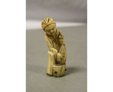 Antique ivory netsuke in the form of a man with net