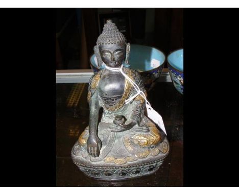 A 16cm high bronze buddha with gilt decoration