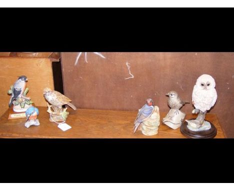 A Poole Pottery figure, together with other ornithological figures 