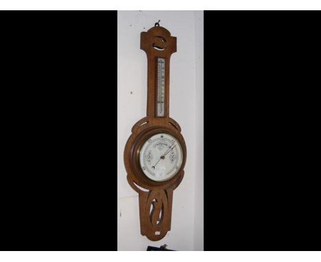 An oak wall barometer/thermometer 