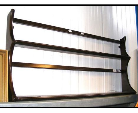 An Ercol wall mounted plate rack 