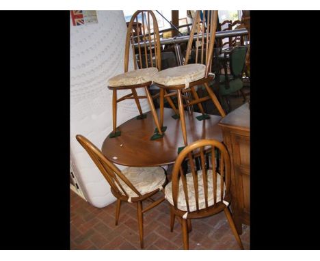 An Ercol oval dining table on square legs - length 120cm, together with a set of four stick back chairs 