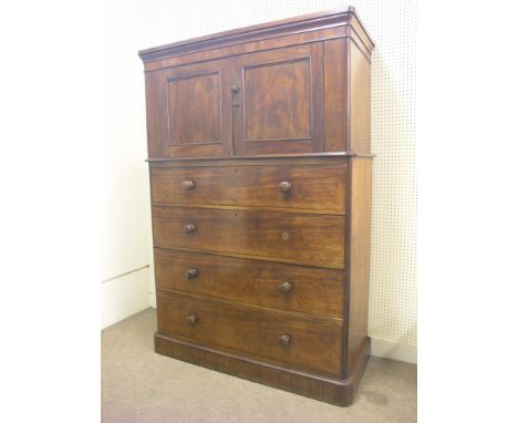 A late Victorian Heal & Son mahogany millinery cupboard on chest, pair of panelled cupboard doors enclosing single shelf, fou