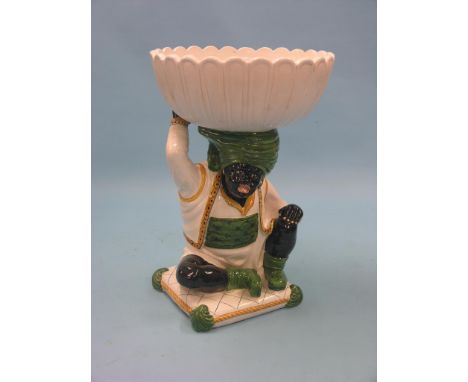 A large ceramic Blackamoor, seated character holding large jardiniere aloft, 29in. high