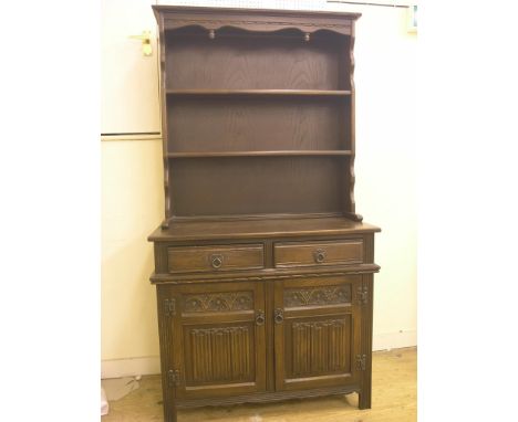 An Old Charm dark oak dining suite, gateleg table, 3ft. 8in., four wheelback chairs and dresser with two-shelf plate rack, 3f