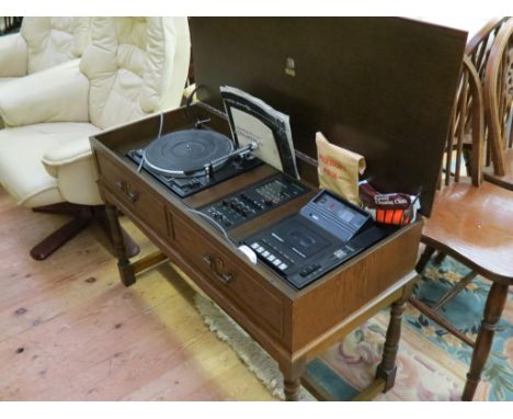 A Dynatron GC 1210PK music centre, featuring Garrard record deck, radio and cassette player, in Jacobean-style dark oak cabin