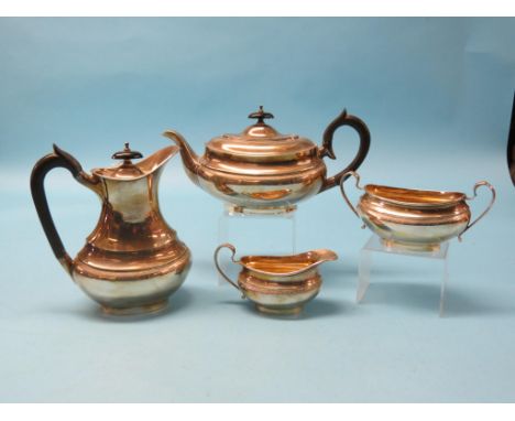 A silver four-piece teaset, teapot, hot water jug, each with hardwood handle, milk jug, oval-shape with engraved borders and 