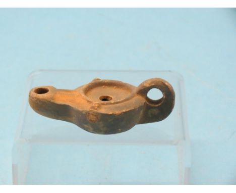 A Roman black slip and terracotta oil lamp, circa 100AD, 3.25in.