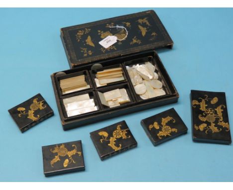 A collection of pearl gaming counters, largely rectangular and fourteen fish-shape