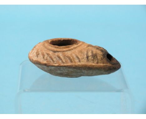 An ancient terracotta oil lamp, eastern Mediterranean, with cast detail, circa 100-200AD, 3.5in.