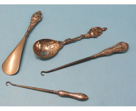 A royal commemorative silver spoon, cast design, London 1897, two silver-handled button hooks and a silver-handled shoe-horn
