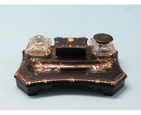 A Victorian papier mache ink-stand with two cut glass wells, mother of pearl inlay, 9in. - one papier mache cover lacking tog