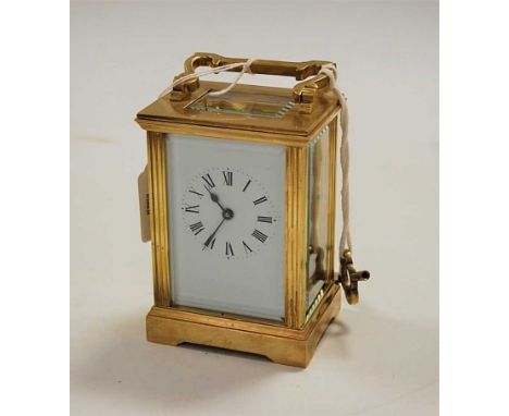 A lacquered brass cased carriage clock, having enamelled dial with Roman numerals, visible platform lever escapement, and bar