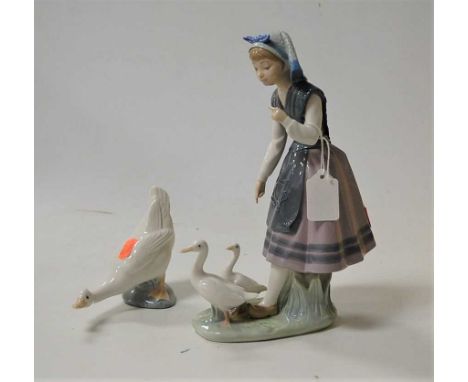 A Lladro porcelain figure group of a girl with ducks; together with a Nao porcelain duck (2)Condition report: Both appear goo