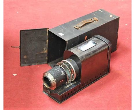 An early 20th century magic lantern, bearing label for Houghton &amp; Butcher Ltd of Ensign House, London WC1, in tin case; t