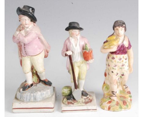 An early 19th century Staffordshire pearlware figure of a man in standing pose wearing a black hat, with purple jacket and wr