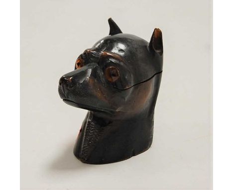 A late Victorian carved pine novelty table lighter in the form of a dogs head, having glass eyes and hinged cover, opening to