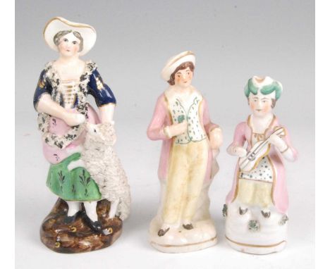 A 19th century Staffordshire figure of a lady, in standing pose with lamb at her knee, in blue dress with green skirt, on nat