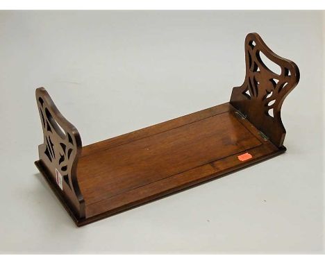 A Victorian walnut book trough, having pierced folding ends