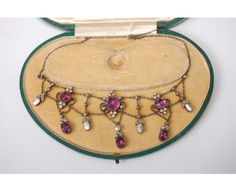 A George V white metal, amethyst, seed pearl and marcasite set necklet, arranged as three round cut and three oval cut amethy