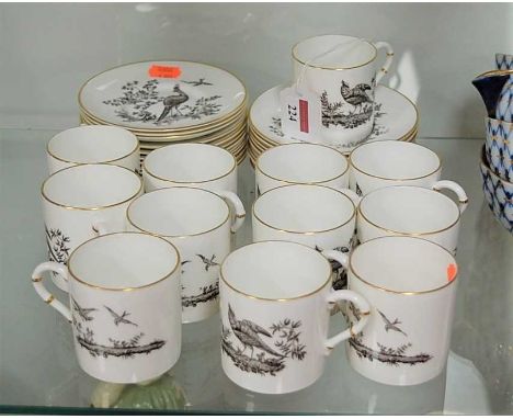 A Royal Worcester bone china set of twelve coffee cans and saucers, each transfer printed with gamebirds within gilt borders