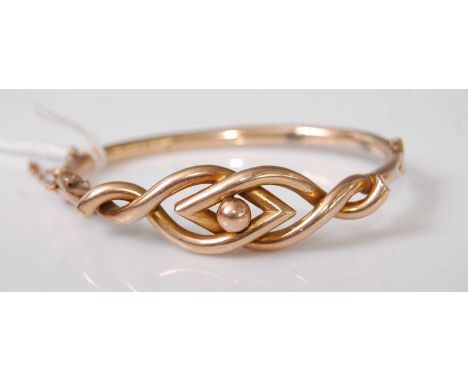 A Victorian yellow metal hollowed bangle, having Celtic Knot type decoration, unmarked but tests as approx 9ct, 9.4g (with so