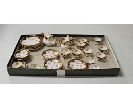 A Crown Staffordshire porcelain dolls part tea set, decorated in bright enamels with floral sprays on a white ground, within 