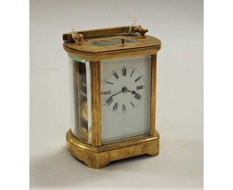 A lacquered brass cased carriage clock, of barrel shape, having enamelled dial with Roman numerals, visible lever escapement 