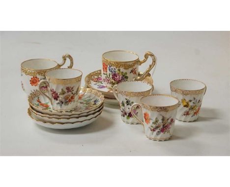 A set of four Dresden porcelain coffee cans and saucers, each decorated with floral sprays; together with a pair of continent