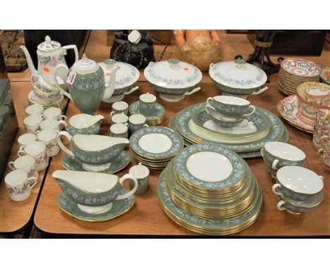 A Wedgwood bone china six place setting tea and dinner service, on a green ground within floral border; together with a Royal