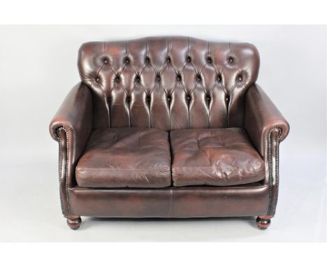 A Button Back Chesterfield Style Two Seater Sofa in Brown Leather Effect, 120cm wide 