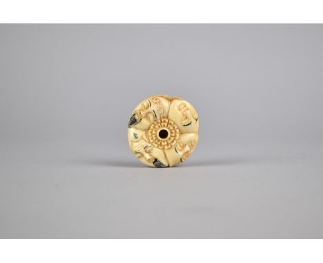 A Reproduction Bone Netsuke in the form of Faces in a Round, Signed, 4cm diameter 