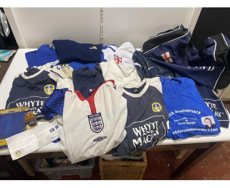 A large selection of assorted Leeds United and England shirts with promotional and other ephemera including a 2004 champagne 