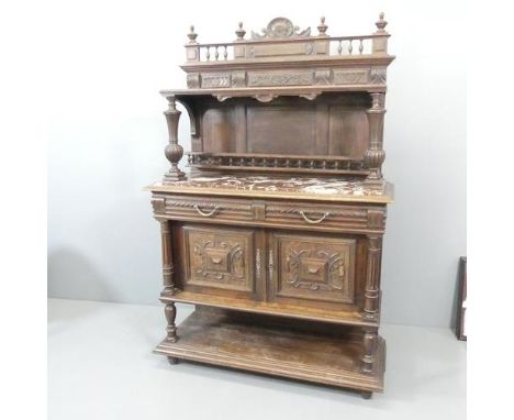 An Antique French Henri II style oak marble-topped buffet / sideboard, with two drawers above two panelled doors and carved d