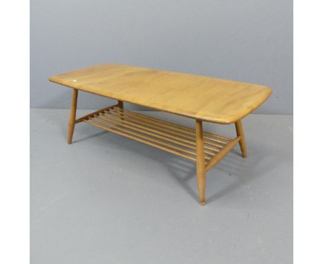 ERCOL A mid-century Windsor model 459 two-tier coffee table, with blue maker's label. 104x36x46cm.Good used condition. Some l