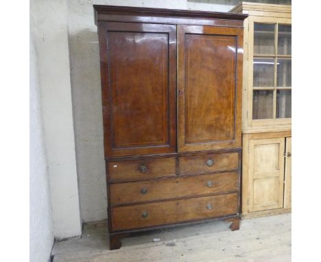 A 19th century mahogany three-section linen-press, the top section having a rail-fitted interior.One bracket foot detatched b