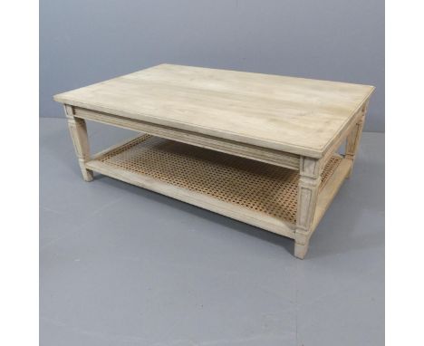 SUZIE WATSON DESIGNS - A contemporary light oak two-tier rectangular coffee table, with cane under-tier and carved decoration