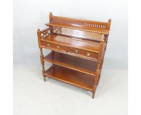 A continental mahogany three-tier buffet, with raised mirror back and two drawers, and carved and pierced decoration. 85x105x