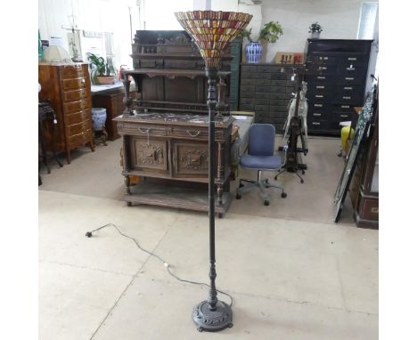 A brass standard lamp on pedestal base, with fluted decoration and Tiffany style multi-coloured lead-light shade. Height to b