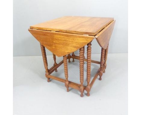 An antique oak square topped drop-leaf occasional table with bobbin turned supports. 62x64cm, opens to 101cm.Damage to one fo