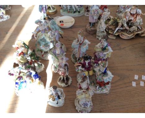 Ten ceramic figurines with gilded detailing including girl with book and couple with lamb.