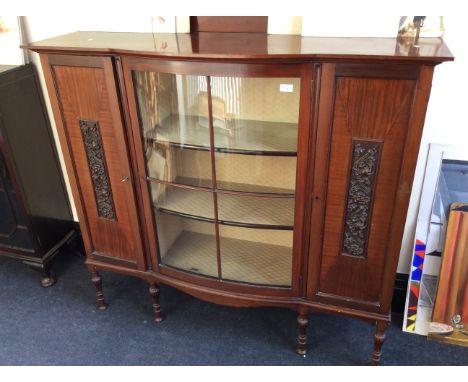 An early 20th Century mahogany china display cabinet with glazed bow from centre flanked with doors.