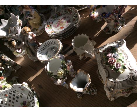 A display dish on stand, a ceramic box and four vases with ceramic figurines and flower detail.