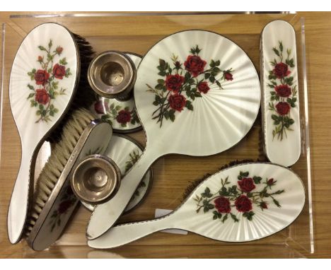 A matched silver and guilloche enamel dressing table set, consisting of two hair brushes, two hand brushes, a hand held mirro