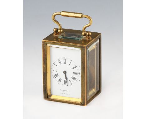 An early 20th Century French miniature brass carriage by Tiffany & Co, the brass body having bevelled glass panels and top wi