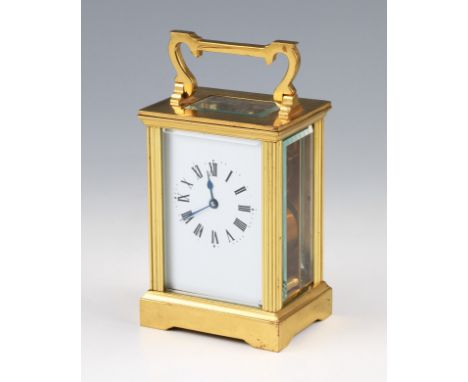 A 20th Century French brass carriage clock with bevelled edge glass panels and top, the white enamel face having black Roman 