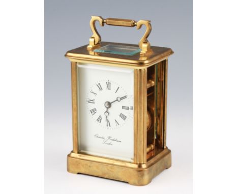 A 20th Century brass carriage clock by Charles Frodsham, London, the brass body having bevelled edge glass panels and top, on