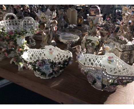 Three ceramic display vases with intricate flower detailing.